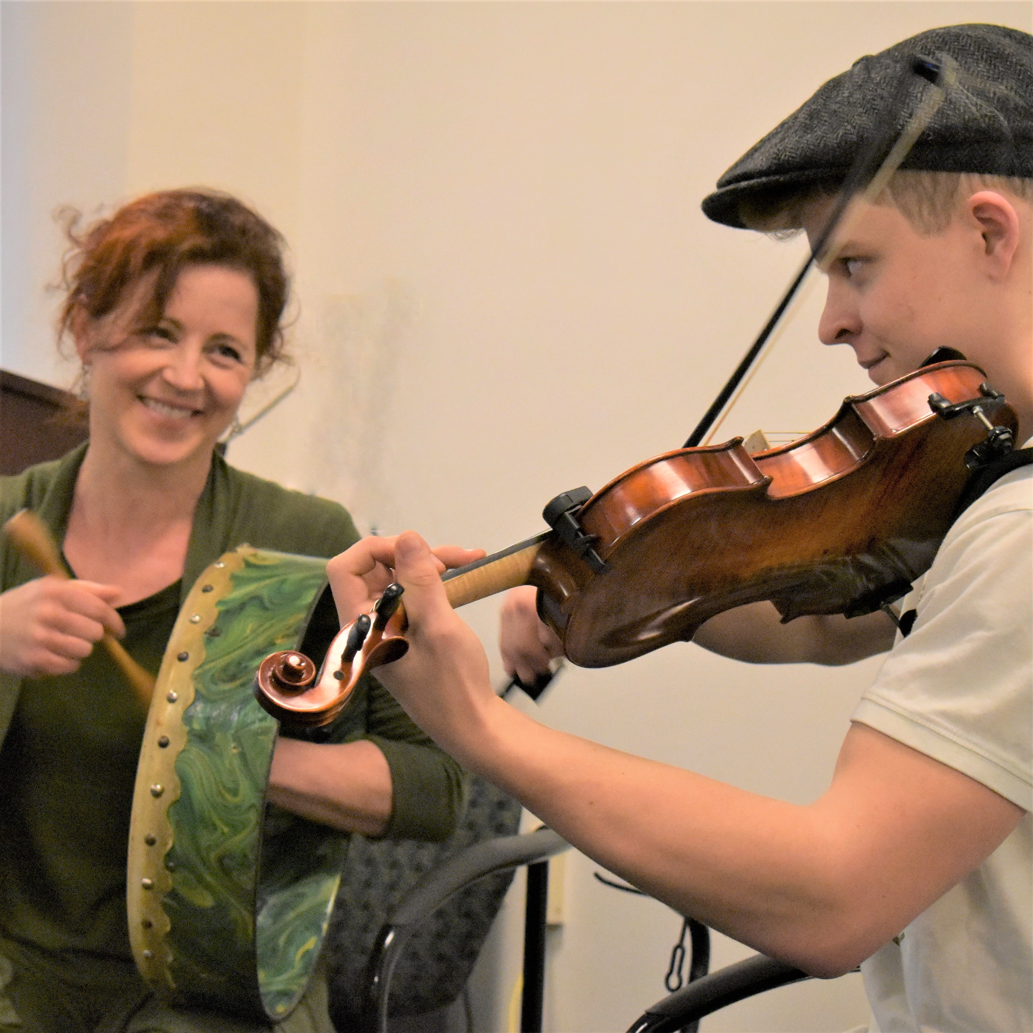 Nancy Bell with an Irish drum and Calum Bell with a fiddle.